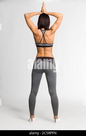 girl in gray sweatpants and top stands in a Boxing pose on a white  background. The concept of a strong woman Stock Photo - Alamy