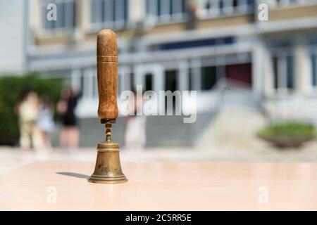 An old school hand bell used to call students back to their studies - selective focus, copy space Stock Photo