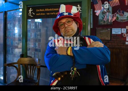 An Israeli man dressed in a particularly patriotic Uncle Sam outfit during United States Fourth of July Independence Day celebration in Mike's Place pub in West Jerusalem Israel Stock Photo