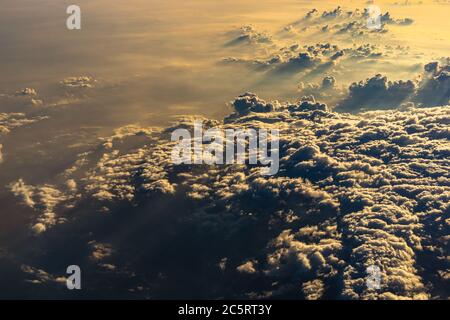 Beautiful sunrise sky above clouds with dramatic light. Cabin view from airplane Stock Photo