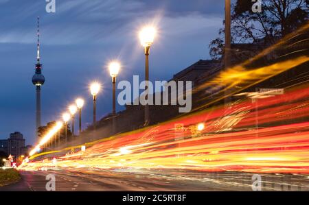 Berlin, Germany. 05th July, 2020. The vehicles on Karl Marx Allee in the direction of the television tower can only be recognised as coloured light strips. (shot with long time exposure) Credit: Paul Zinken/dpa/Alamy Live News