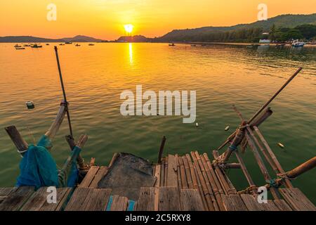 Wooden dock in the sea at sunset. Stock Photo