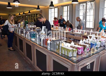 GRASSE, FRANCE - MAY 3: Perfume Shop inside Fragonard factory on May 3, 2013 in Grasse, France. People choose and buy perfume. Fragonard perfumery is Stock Photo
