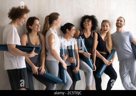 Happy young multiracial people feeling excited waiting for yoga training. Stock Photo