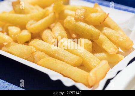 Fried French fries, served on a cardboard tray Stock Photo