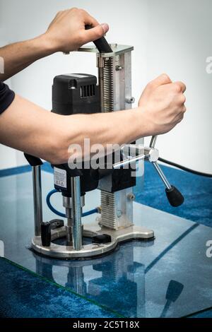 Glazing drilling hole in glass, Machine for drilling in glass material Stock Photo