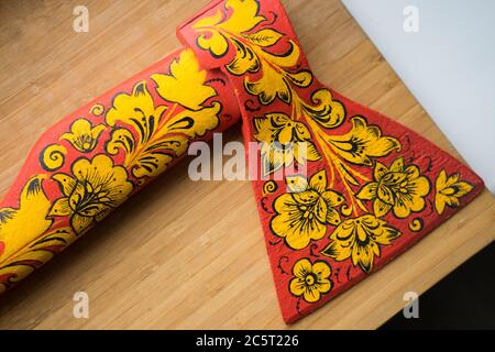 axe in Khokhloma. An axe painted in Russian folk style. Russian traditions Stock Photo