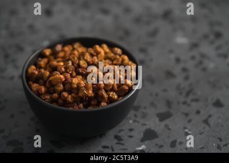 dried seaberry buckthorn in black bowl on terrazzo countertop with copy space Stock Photo