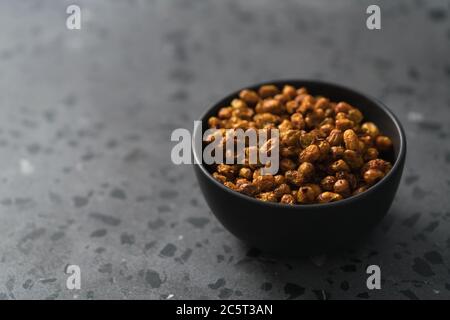dried seaberry buckthorn in black bowl on terrazzo countertop with copy space Stock Photo