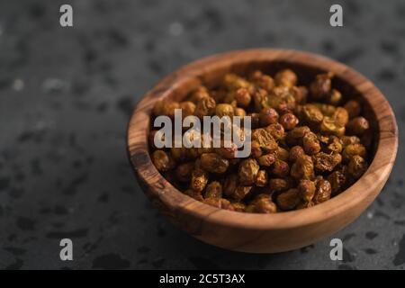 dried seaberry buckthorn in olive bowl on terrazzo countertop with copy space Stock Photo