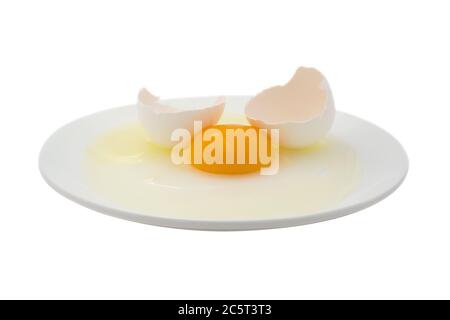 Broken egg on a dish isolated on a white. Clipping path included. Stock Photo