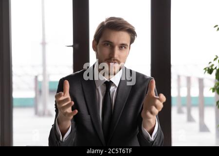 Young Caucasian businessman talk on video call in office Stock Photo