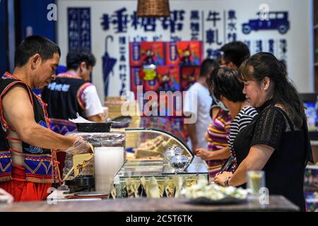 Yangshuo, China's Guangxi Zhuang Autonomous Region. 4th July, 2020. Visitors shop on West Street in Yangshuo County, south China's Guangxi Zhuang Autonomous Region, July 4, 2020. Credit: Lu Xianting/Xinhua/Alamy Live News Stock Photo