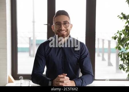 Portrait of happy Arabic businessman talk on video call Stock Photo