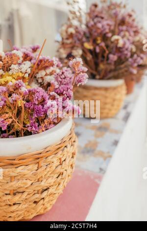 Closeup of a bouquet of dried flowers in vintage ceramic vase Stock Photo