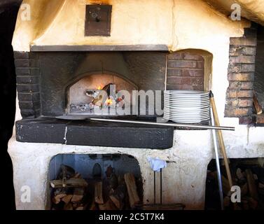 Old stove with burning firewoods. Stock Photo