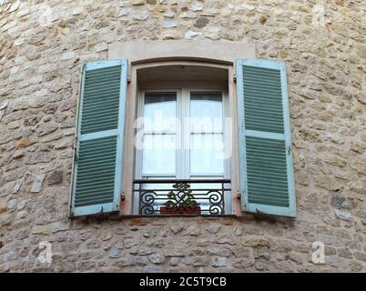 Window on medieval stone wall - Antibes, France Stock Photo