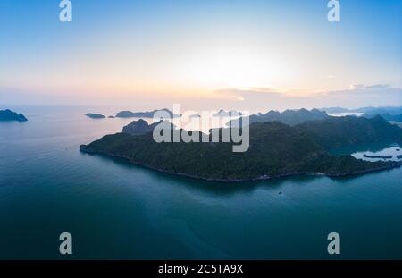 Aerial view of Ha Long Bay Cat Ba island, unique limestone rock islands and karst formation peaks in the sea, famous tourism destination in Vietnam. S Stock Photo