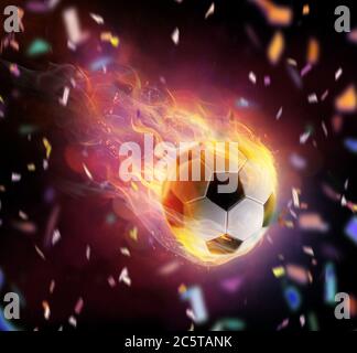 Football ball bright flamy symbol on the black background. Stock Photo