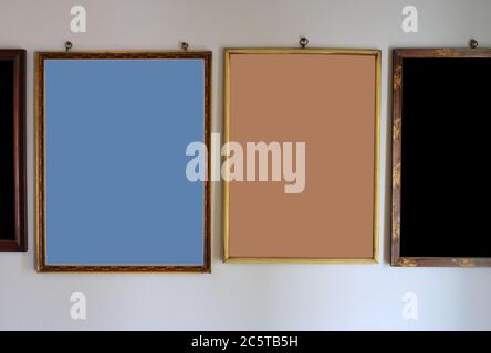 Closeup colorful vintage wooden photo frames hanging on the wall in a room for decoration Stock Photo