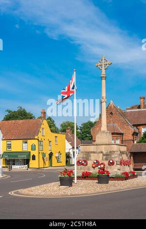 Holt Norfolk UK, view in summer of the Market Place in Holt village showing the war memorial at its centre, Norfolk, East Anglia, UK Stock Photo