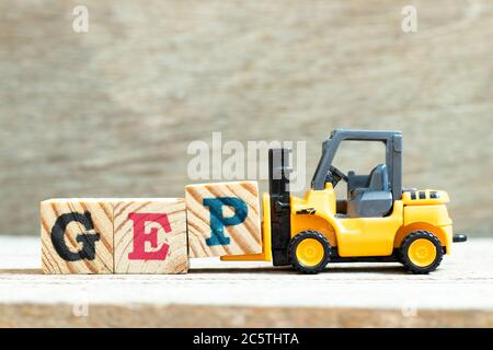 Toy forklift hold letter block p to complete word GEP (abbreviation of good engineering practice) on wood background Stock Photo