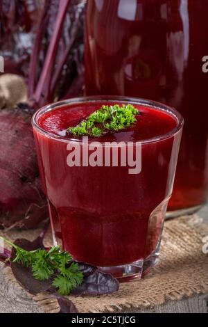 a glass of fresh beetroot juice on an old rustic table Stock Photo