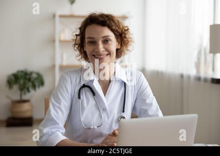 Portrait of smiling female doctor posing at workplace Stock Photo