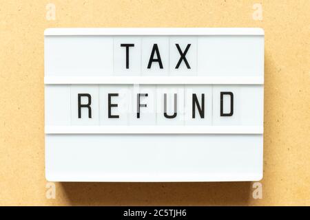 Lightbox with word tax refund on wood background Stock Photo
