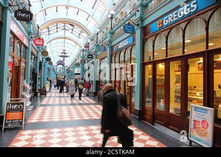 BIRMINGHAM, UK - APRIL 19, 2013: People shop at Great Western Arcade in Birmingham, UK. The shopping gallery is a famous Grade II listed monument, bui Stock Photo