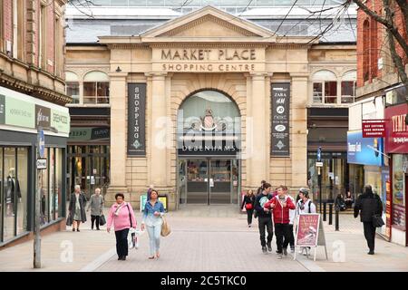 BOLTON, UK - APRIL 23, 2013: People walk along a shopping street in Bolton, UK. Bolton is part of Greater Manchester, one of largest population areas Stock Photo