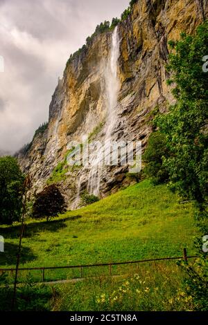 Famous Staubbach Falls in the Lauterbrunnen valley, Jungfrau region, Bernese Oberland, Switzerland, overcast day in summer. Portrait orientation Stock Photo