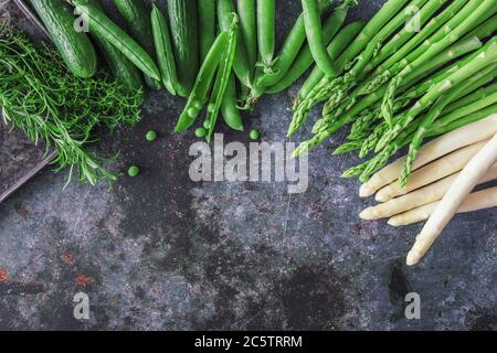 Group of green vegetables, flatlay on grey stone, copy space Stock Photo