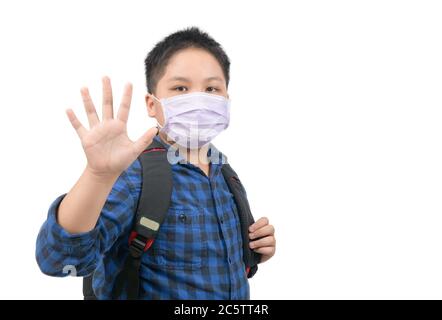 Asian boy student wear mask and waving goodbye before go to school isolated on white background. back to school with new normal concept Stock Photo