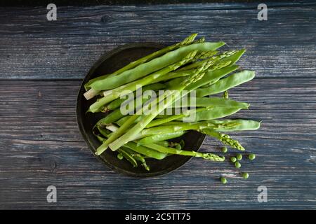 Green healphy vegetables on a wooden plate Stock Photo