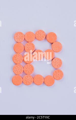 The letter B made of round pills. Stock Photo