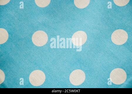 Blue cotton fabric with white polka dots closeup. Stock Photo