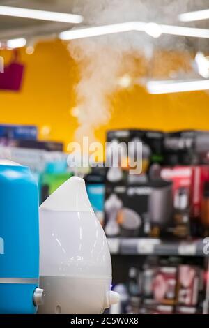 Demonstration of a humidifier with steam in a store. Health care device. Stock Photo