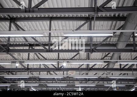 Metal structures on the ceiling in a manufacturing factory. Stock Photo
