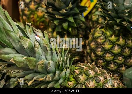 Ripe juicy pineapples in the store. Tropical fruits for diet food. Stock Photo