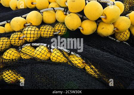 Black fishing net with orange corks, Mahe island, Seychelles Stock Photo