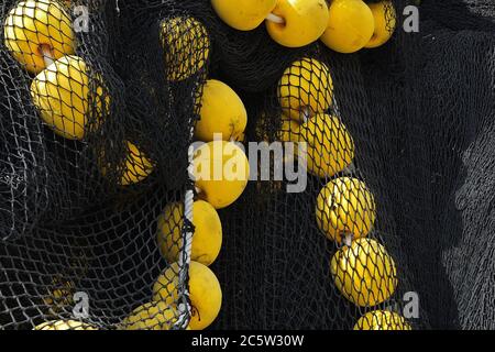 Black fishing net with orange corks, Mahe island, Seychelles Stock Photo