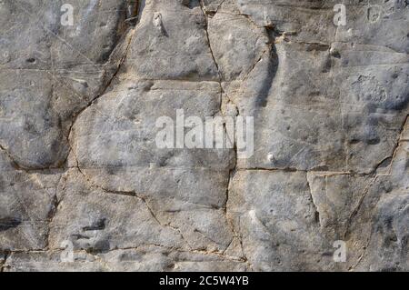 Texture of a dark gray granite stone or background for design. The surface of the stone from the texture surfaces for the tiles. Stock Photo
