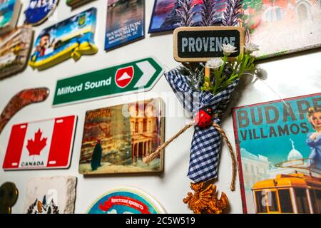 Souvenir fridge magnets of global destinations and landmarks, with focus on a magnet from Provence, France. Stock Photo