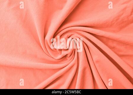 Coral pink delicate fabric draped and spun. Closeup. Stock Photo