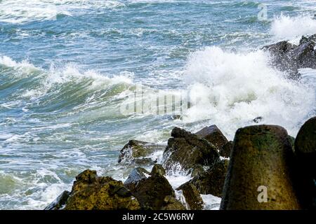 view of the stormy sea, waves splashing against the concrete pier Stock Photo