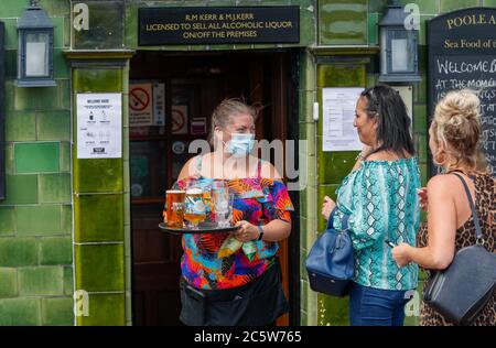 Poole, UK. 5th July 2020. Michelle Kerr, landlady at the Poole Arms on a bustling Poole Quay, Dorset as cafes and pubs reopened this weekend . Credit: Richard Crease/Alamy Live News Stock Photo