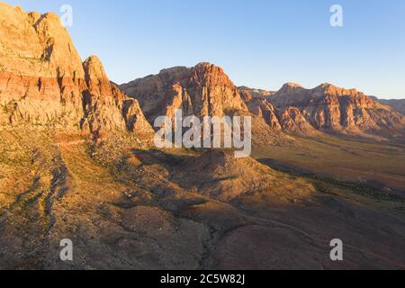 An aerial view shows a rugged mountain landscape that rises from the desert surrounding Las Vegas, Nevada. This dry area averages over 95 degrees F. Stock Photo