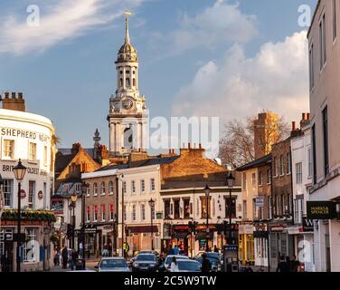 London, England, UK - April 11, 2010: Sun shines on the shops, pubs and resturants of Greenwich Church Street in South East London. Stock Photo