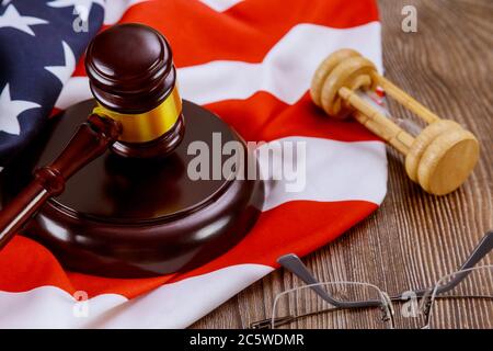American flag, a US judge legal office with hourglass judge's gavel on wooden table Stock Photo